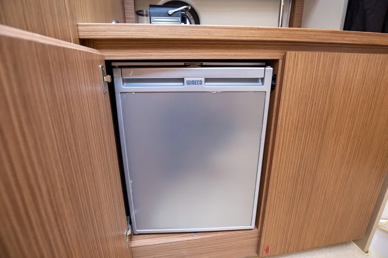  Yacht Photos Pics Compact fridge in 2017 Azimut 34 yacht's wooden cabinet interior.
