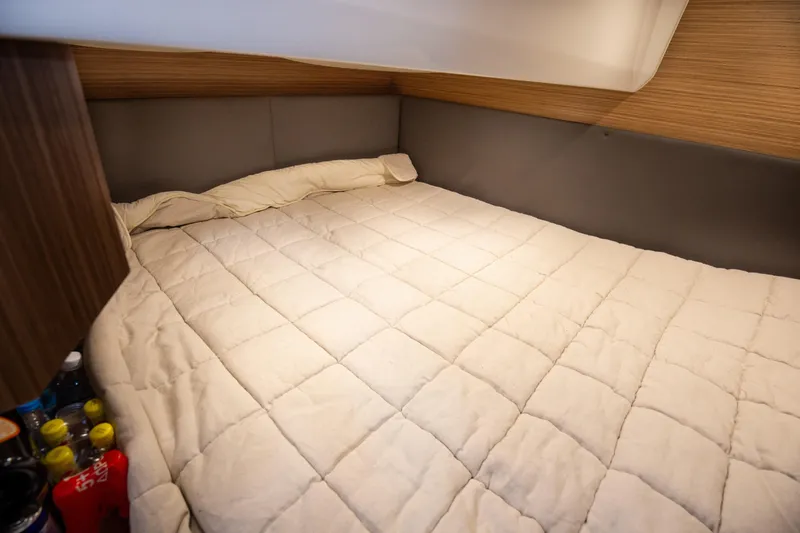  Yacht Photos Pics Cozy cabin bed in 2017 Azimut 34 yacht with wooden accents and soft bedding.