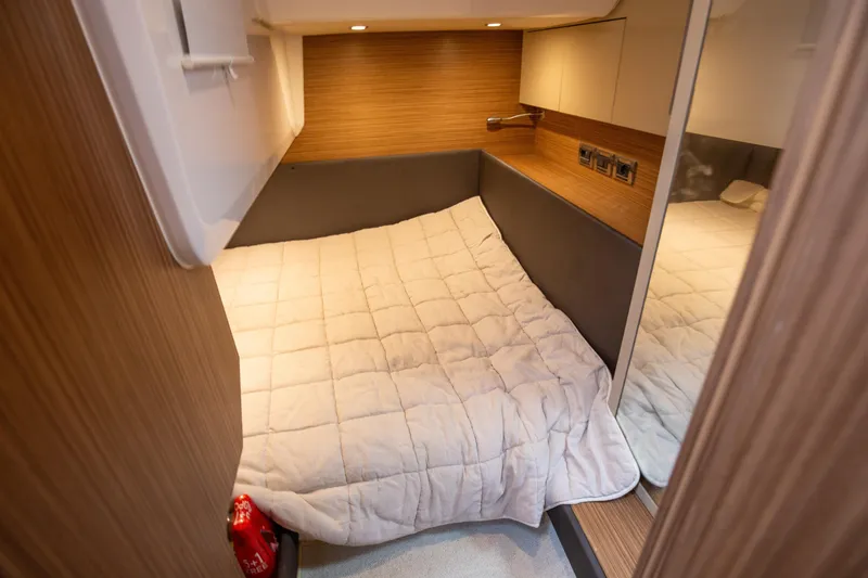  Yacht Photos Pics Cozy cabin interior of 2017 Azimut 34 yacht with bed and wood paneling.