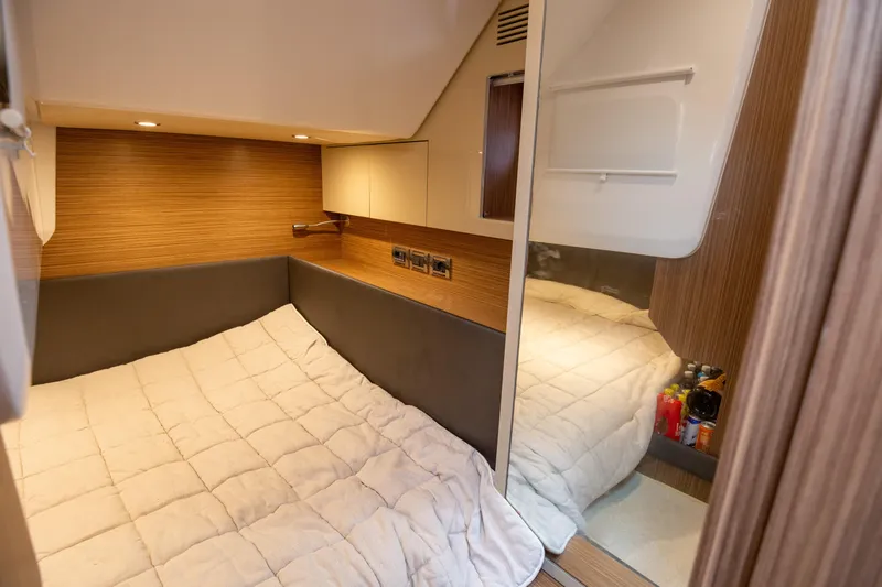  Yacht Photos Pics Cozy cabin interior of 2017 Azimut 34 yacht with modern wood paneling and soft lighting.