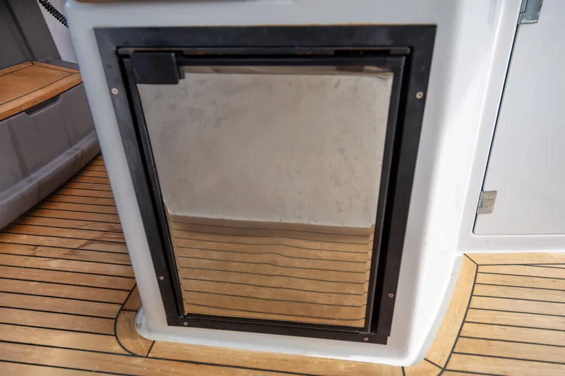  Yacht Photos Pics Azimut 34 yacht interior, 2017 model, featuring a sleek stainless steel refrigerator on teak flooring.