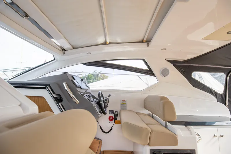  Yacht Photos Pics Interior of 2017 Azimut 34 yacht, featuring modern helm and beige seating.