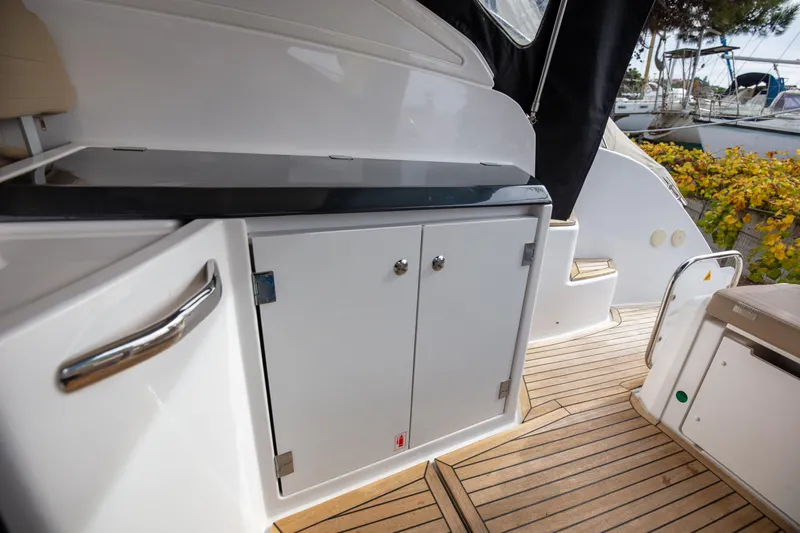  Yacht Photos Pics 2017 Azimut 34 yacht deck with sleek cabinetry and wooden flooring.