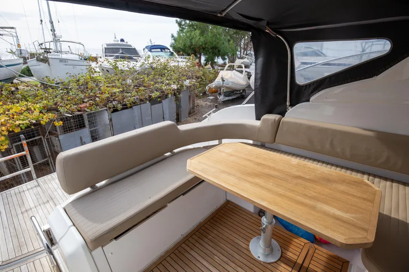  Yacht Photos Pics Interior of 2017 Azimut 34 yacht with wooden table and cushioned seating.