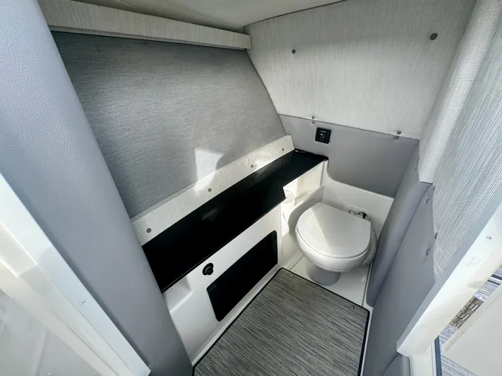  Yacht Photos Pics 2022 Cobalt R8 Outboard boat interior bathroom with modern design and compact toilet.