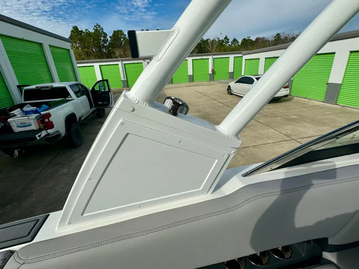  Yacht Photos Pics 2022 Cobalt R8 Outboard boat detail near storage units and parked vehicles.