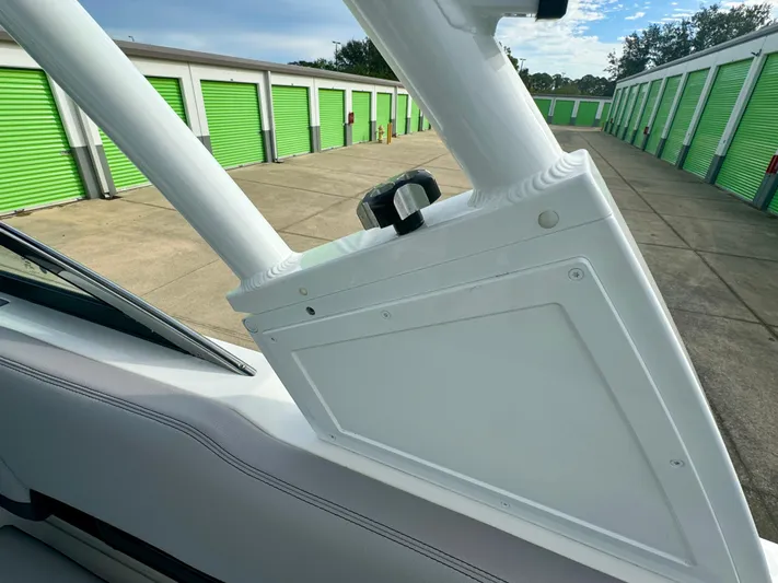  Yacht Photos Pics 2022 Cobalt R8 Outboard boat detail near green storage units.