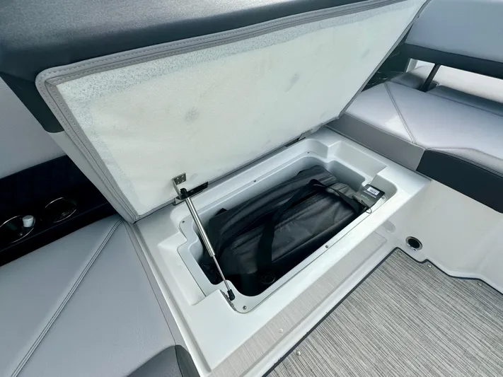  Yacht Photos Pics 2022 Cobalt R8 Outboard boat storage compartment with open lid and interior view.