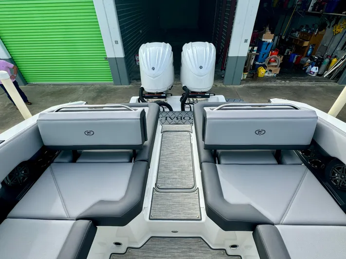  Yacht Photos Pics 2022 Cobalt R8 Outboard boat interior with twin engines, gray seating, and storage area.