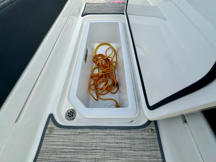  Yacht Photos Pics 2022 Cobalt R8 Outboard storage compartment with coiled orange rope.