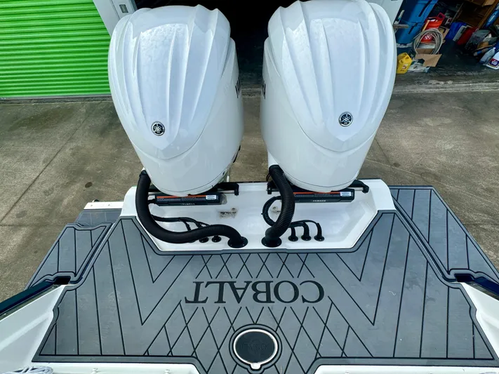  Yacht Photos Pics 2022 Cobalt R8 Outboard boat with dual engines on a dock.