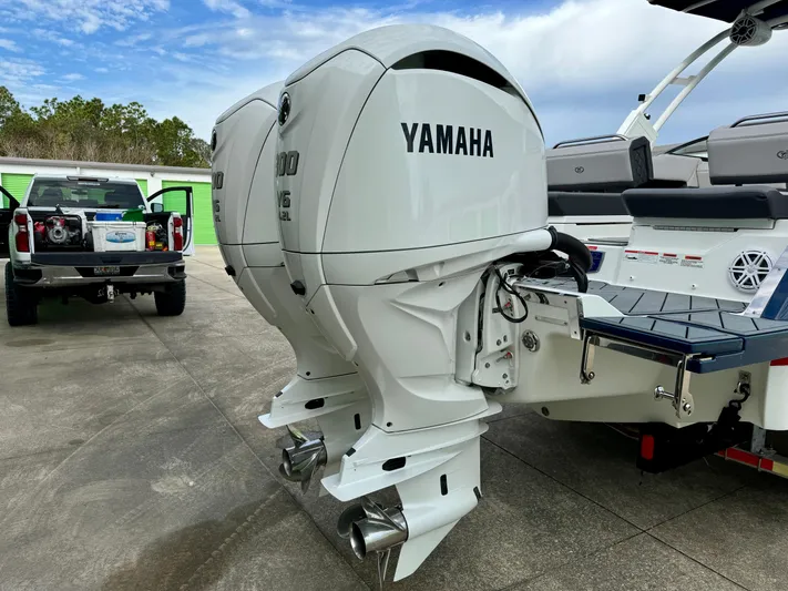  Yacht Photos Pics 2022 Cobalt R8 Outboard with dual Yamaha engines, parked outdoors.