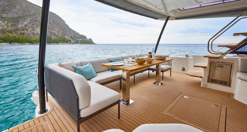  Yacht Photos Pics Luxurious Prestige M48 yacht deck with elegant seating, dining table, and scenic ocean view, 2025 model.
