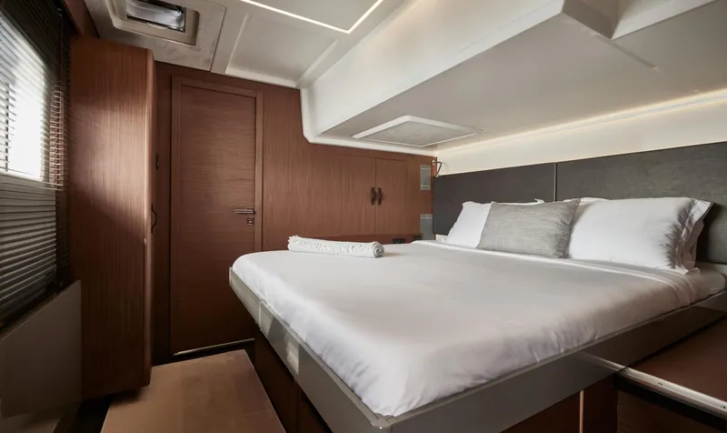  Yacht Photos Pics Luxurious bedroom interior of 2025 Prestige M48 yacht with modern design and cozy bedding.