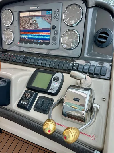 Aztec Princess Yacht Photos Pics Control panel of a 2006 Sea Ray 44 Sundancer with navigation and throttle controls.