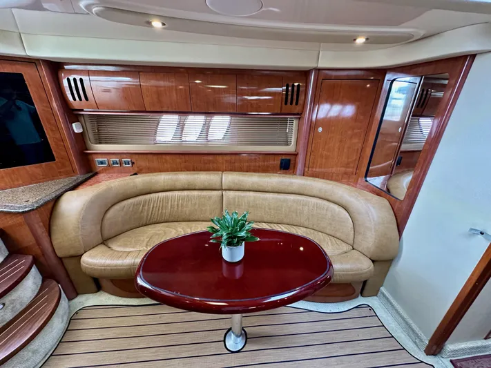 Aztec Princess Yacht Photos Pics Interior of 2006 Sea Ray 44 Sundancer yacht with leather seating and wooden table.