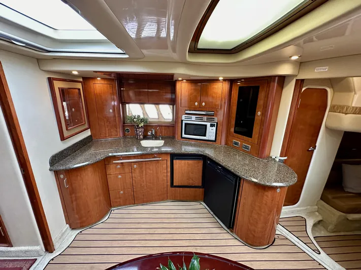 Aztec Princess Yacht Photos Pics Luxurious kitchen interior of 2006 Sea Ray 44 Sundancer yacht with wood cabinetry.