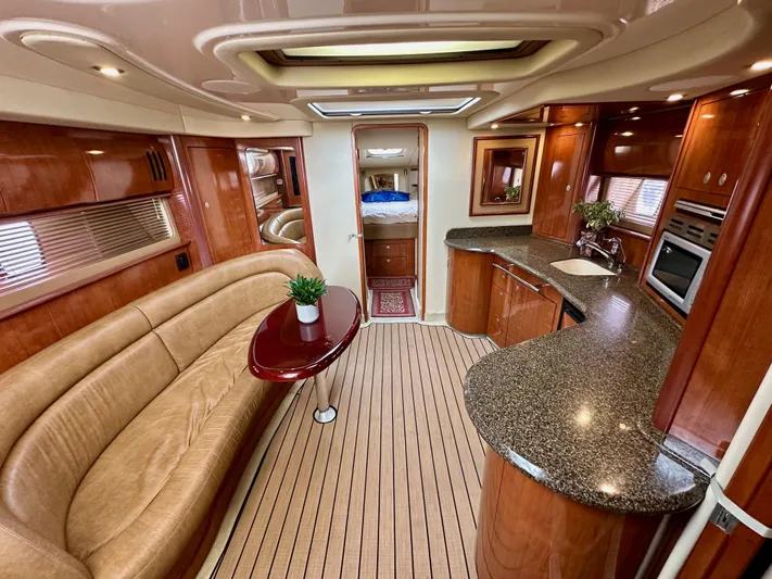 Aztec Princess Yacht Photos Pics Luxurious interior of 2006 Sea Ray 44 Sundancer yacht with elegant wood finishes and modern amenities.