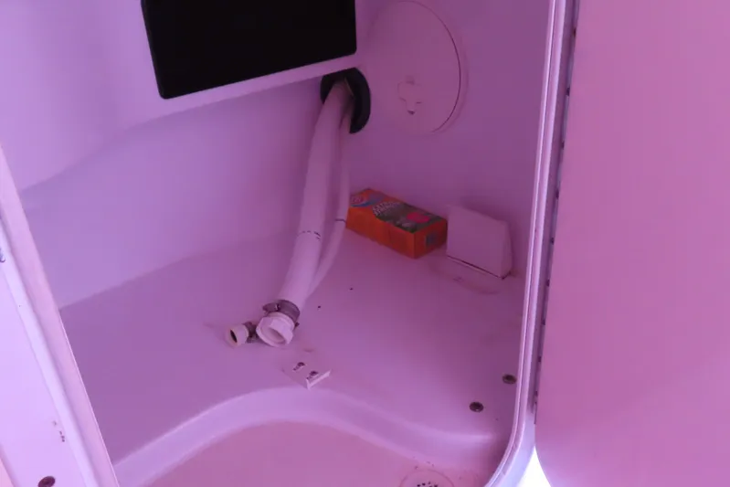  Yacht Photos Pics 2009 Donzi 35ZR interior compartment with hose and storage items.