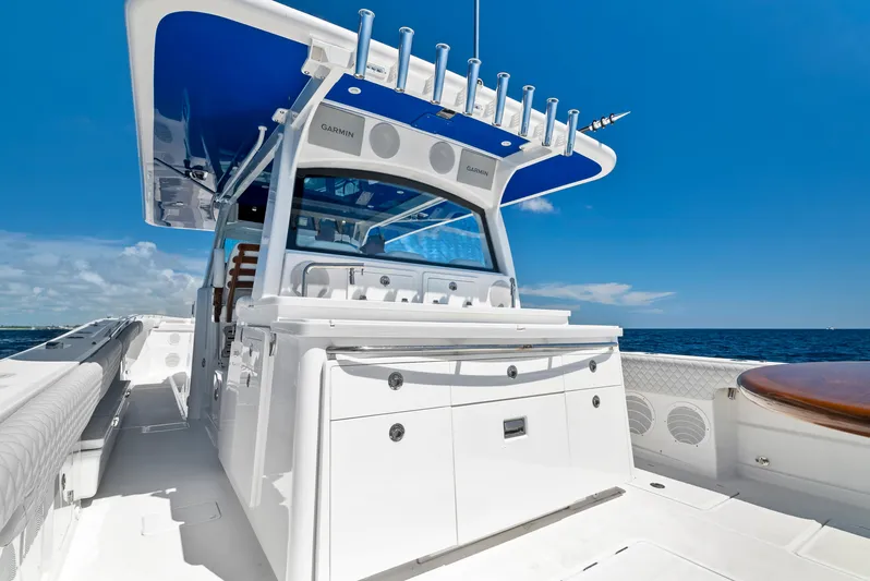 Strong III Yacht Photos Pics 2022 HCB Suenos boat with sleek design, white deck, and blue canopy on open sea.