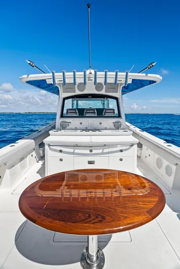 Strong III Yacht Photos Pics 2022 HCB Suenos boat with wooden table, open sea view, clear blue sky.