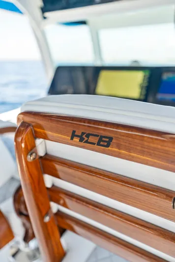 Strong III Yacht Photos Pics 2022 HCB Suenos boat interior with wooden seating and branded logo.