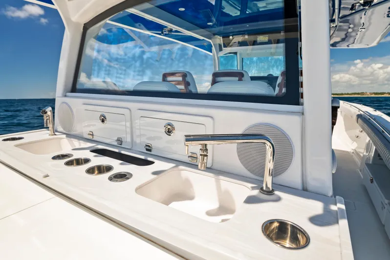 Strong III Yacht Photos Pics 2022 HCB Suenos boat interior with sleek sink and faucet, ocean view in background.