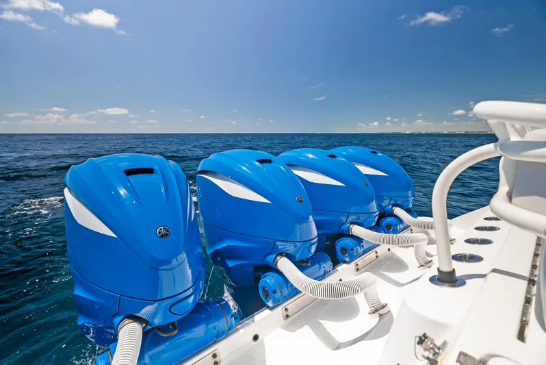 Strong III Yacht Photos Pics Four blue outboard motors on a 2022 HCB Suenos boat in open sea.