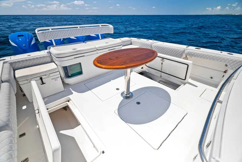 Strong III Yacht Photos Pics 2022 HCB Suenos boat deck with seating and wooden table on open sea.