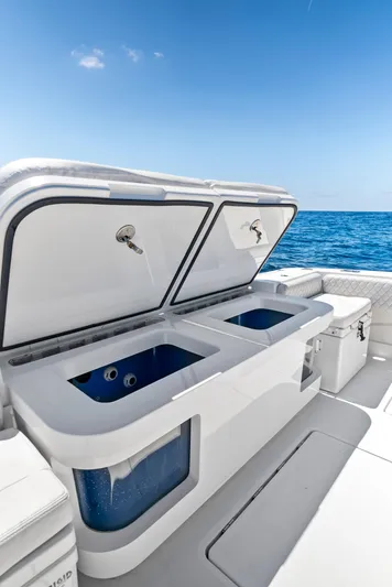 Strong III Yacht Photos Pics 2022 HCB Suenos boat with open storage compartments, ocean view, and clear blue sky.