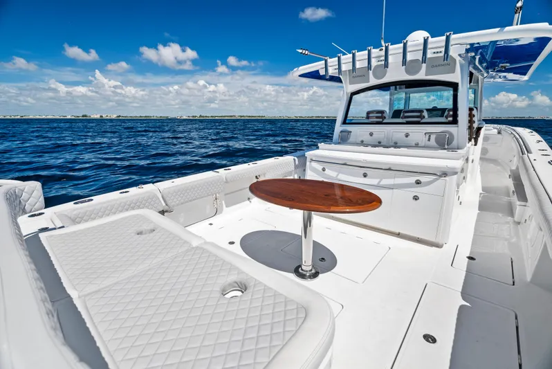 Strong III Yacht Photos Pics 2022 HCB Suenos boat with white seating and wooden table on open ocean.