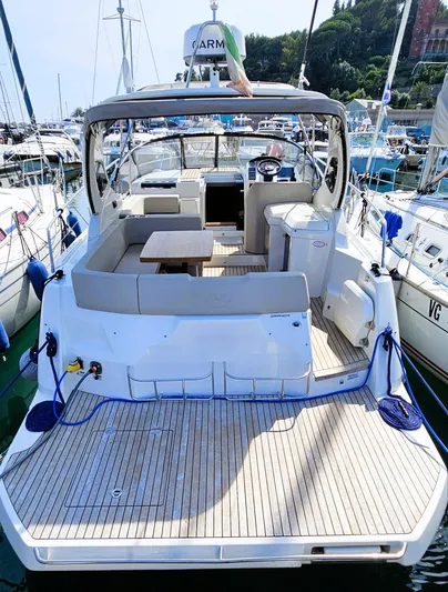  Yacht Photos Pics 2023 Cranchi Z35 yacht with spacious deck and seating, docked at a marina.