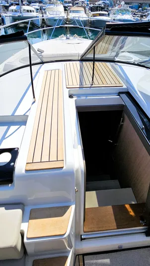  Yacht Photos Pics 2023 Cranchi Z35 yacht deck with wooden accents and marina view.