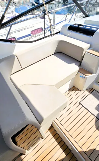 Yacht Photos Pics 2023 Cranchi Z35 yacht interior with beige seating and wooden flooring.