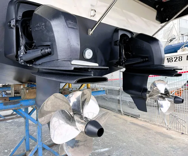  Yacht Photos Pics 2023 Cranchi Z35 boat propellers and stern drives in a maintenance area.