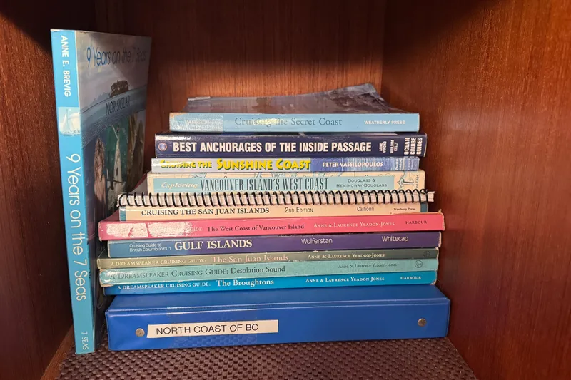 Lone Wolf Yacht Photos Pics Bookshelf with nautical guides and cruising books