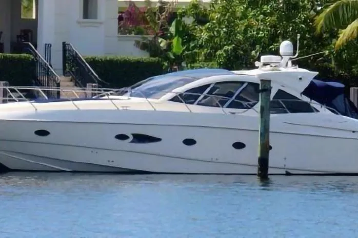 Sol Yacht Photos Pics 2010 Azimut Atlantis 54 yacht docked by waterfront home.