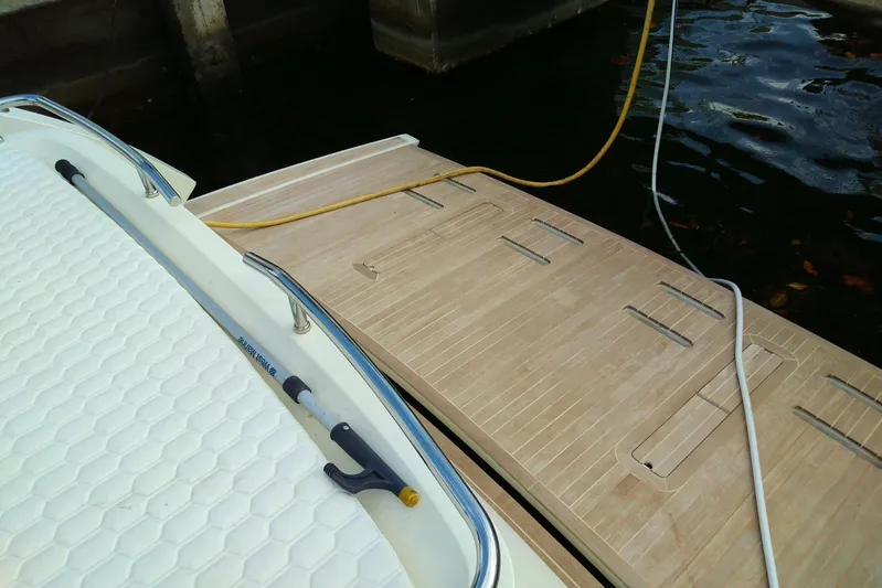 Sol Yacht Photos Pics 2010 Azimut Atlantis 54 yacht docked with visible deck and water hoses.