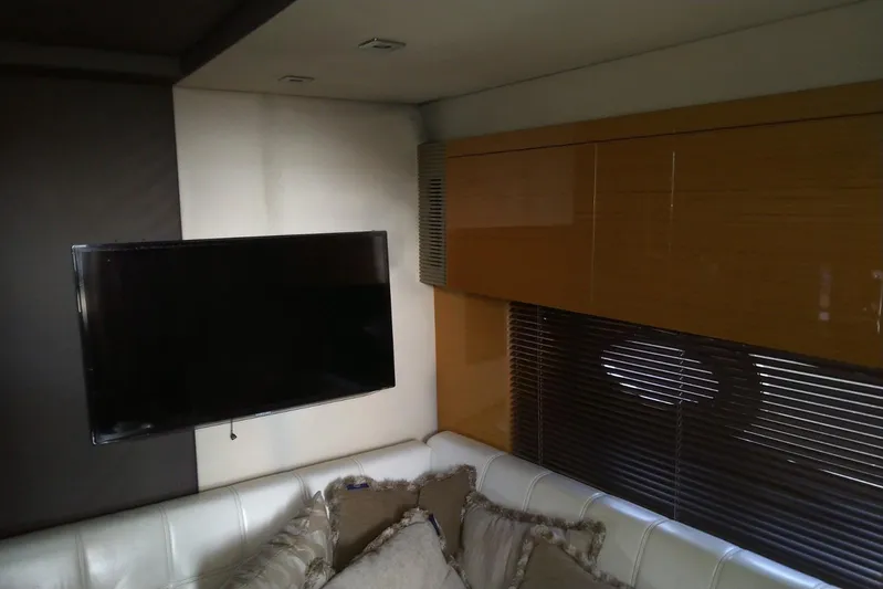 Sol Yacht Photos Pics Interior of 2010 Azimut Atlantis 54 yacht with TV, sofa, and wooden cabinets.