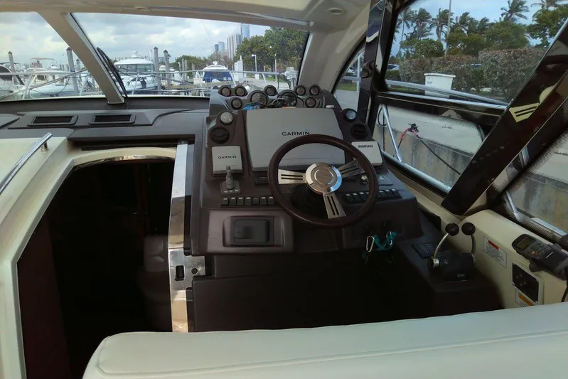 Sol Yacht Photos Pics Cockpit of 2010 Azimut Atlantis 54 yacht with steering wheel and navigation equipment.