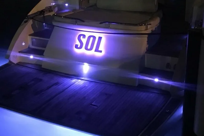 Sol Yacht Photos Pics Azimut Atlantis 54 yacht, 2010 model, illuminated at night with "SOL" signage.