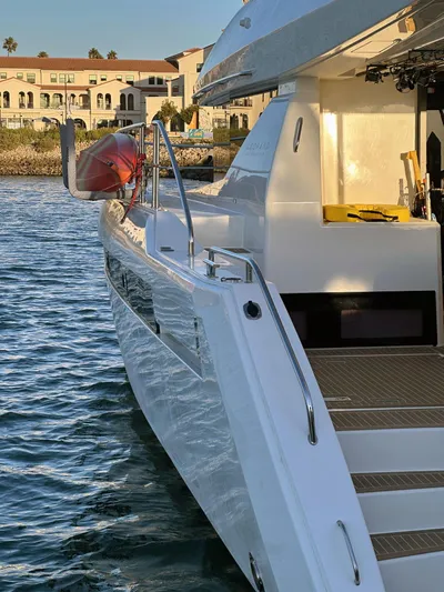 Hamlet Yacht Photos Pics 2023 Leopard 46PC yacht docked by waterfront buildings, showcasing sleek design and modern features.