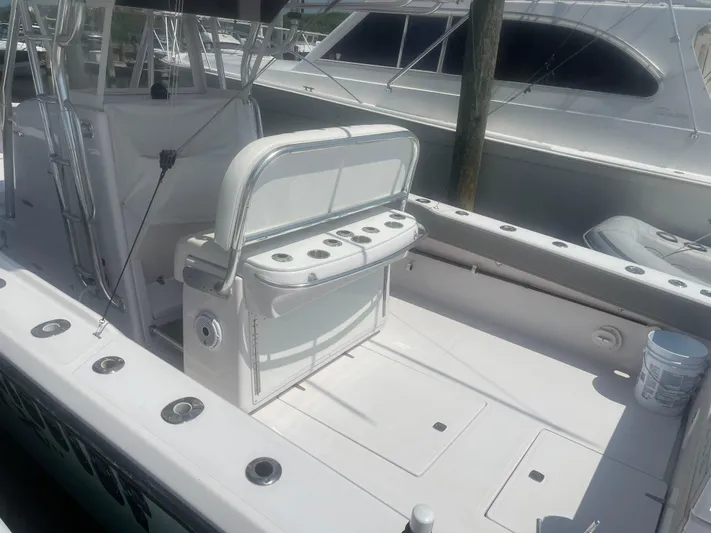  Yacht Photos Pics 2009 Venture 34 CC boat interior with seating and rod holders at a marina.