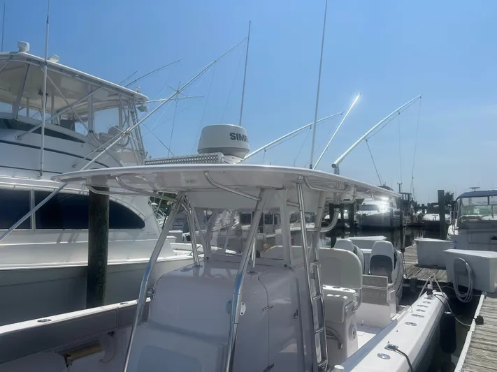  Yacht Photos Pics 2009 Venture 34 CC boat docked at marina under clear blue sky.