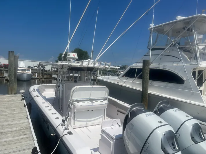  Yacht Photos Pics 2009 Venture 34 CC boat docked, featuring dual outboard engines and a spacious deck.