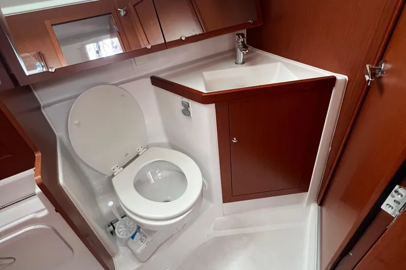  Yacht Photos Pics Beneteau Oceanis 41.1 2020 yacht bathroom with toilet and sink, wooden cabinetry.
