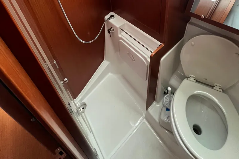  Yacht Photos Pics Bathroom interior of 2020 Beneteau Oceanis 41.1 yacht, featuring shower and toilet.