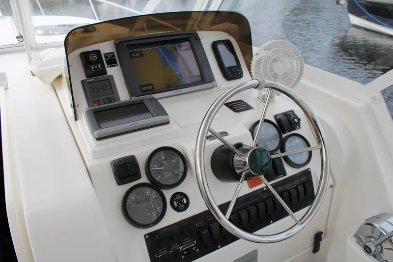 Irish Luck Yacht Photos Pics 2002 Mainship Pilot 34 helm with navigation instruments and steering wheel.