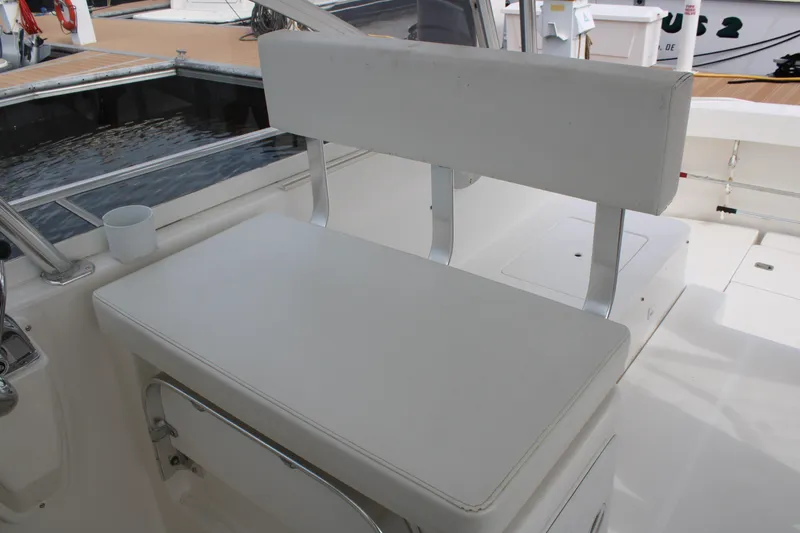 Irish Luck Yacht Photos Pics 2002 Mainship Pilot 34 boat interior with white cushioned seating and cup holder.
