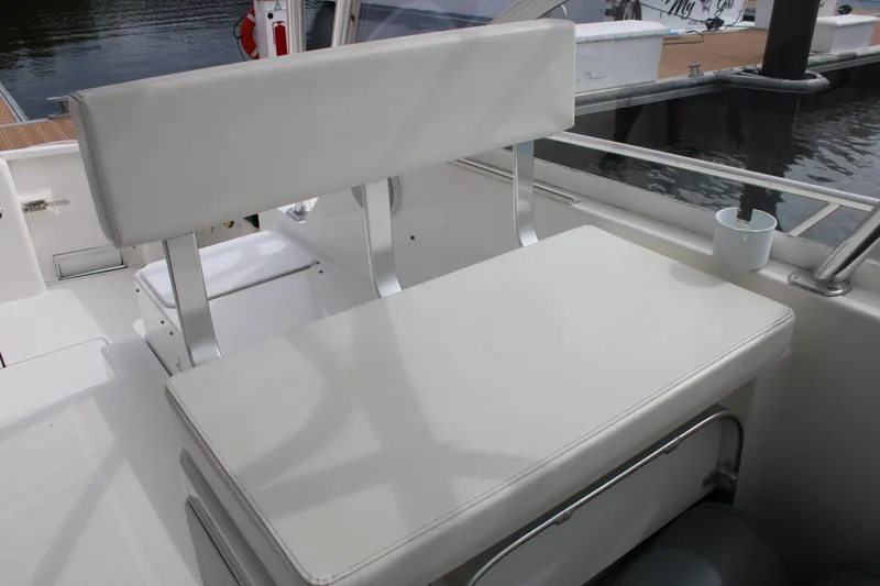 Irish Luck Yacht Photos Pics White seating area on a 2002 Mainship Pilot 34 boat, docked by the water.